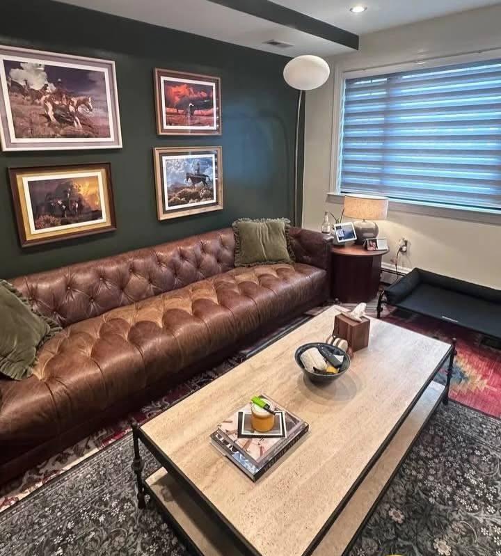 Living room with leather sofa, freshly vacuumed and dusted