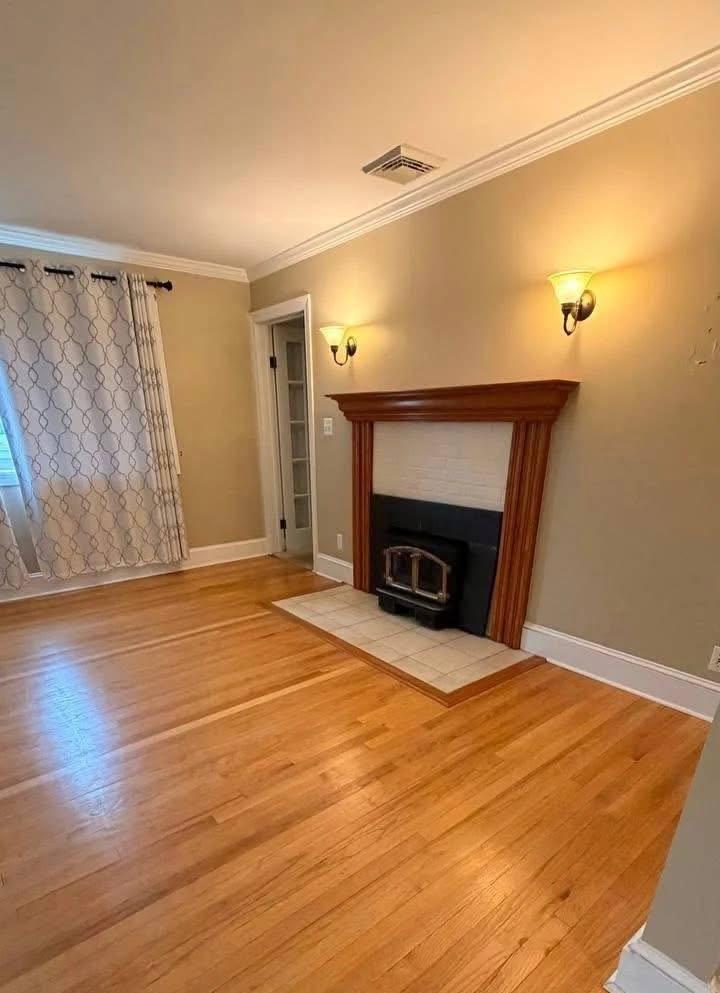 Living room with fireplace and gleaming hardwood floors