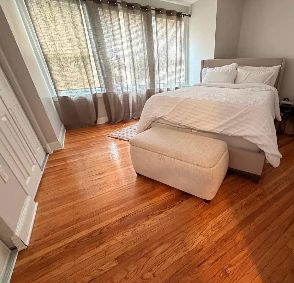 Bedroom with fresh linens and polished hardwood floor